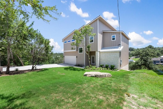 2646 Crazyhorse Pass, Austin, TX 78734 - rear view of house featuring stone siding, concrete driveway, a yard, and an attached garage