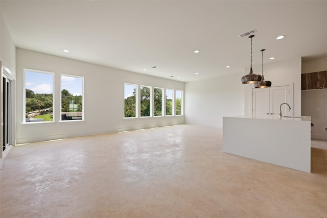 unfurnished living room featuring sink