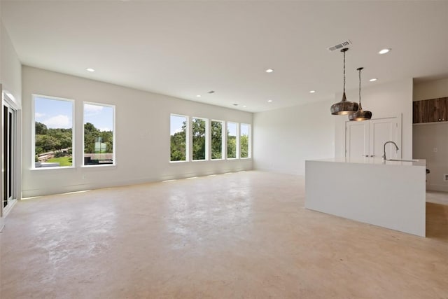2646 Crazyhorse Pass, Austin, TX 78734 - unfurnished living room with a sink, visible vents, recessed lighting, and concrete flooring