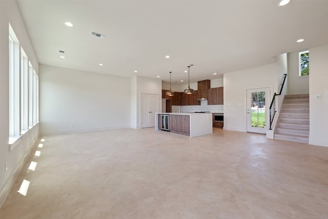 unfurnished living room with wine cooler