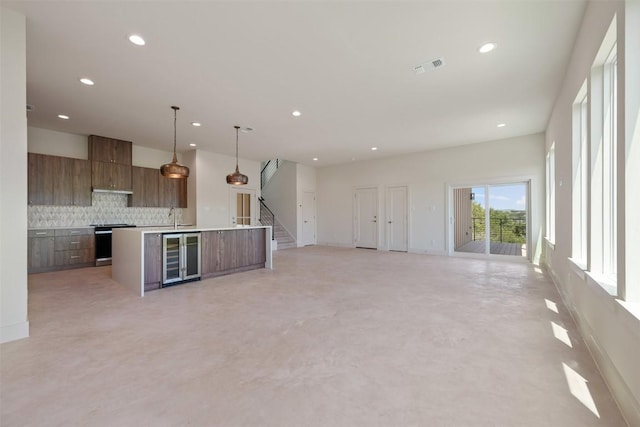 2646 Crazyhorse Pass, Austin, TX 78734 - kitchen with decorative backsplash, visible vents, modern cabinets, wine cooler, and range with electric cooktop