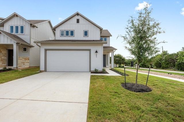 view of front of house with a garage and a front lawn