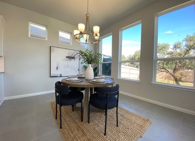 tiled dining room with an inviting chandelier