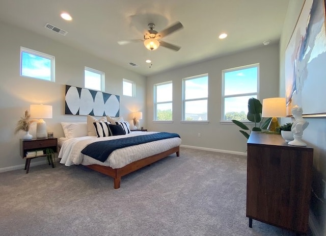 bedroom with multiple windows, ceiling fan, and carpet floors