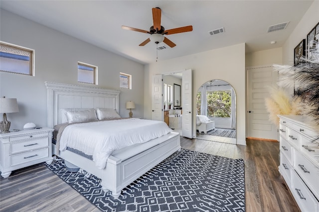 bedroom featuring ceiling fan, dark wood-type flooring, and connected bathroom