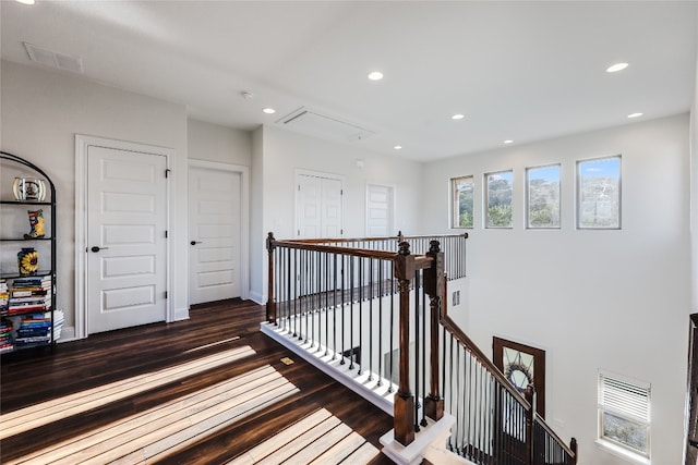 corridor with dark hardwood / wood-style flooring