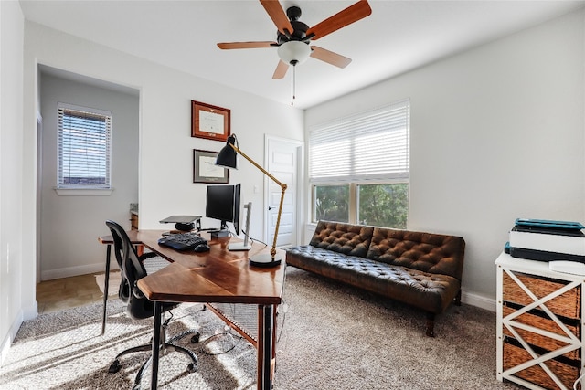 carpeted office space featuring ceiling fan and a healthy amount of sunlight