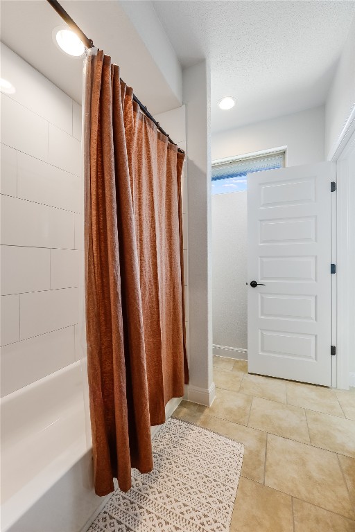 bathroom with shower / bath combination with curtain