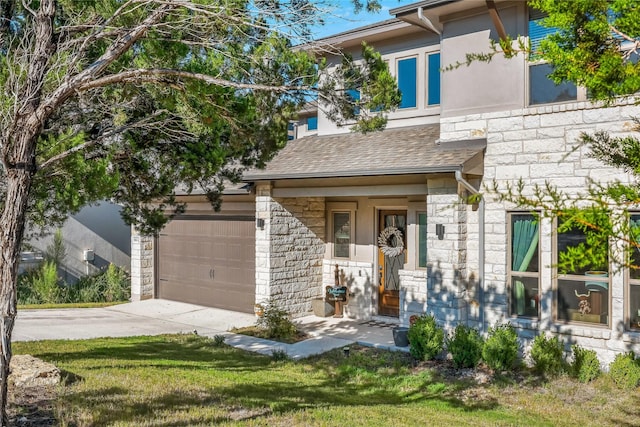 view of front of property featuring a garage and a front yard