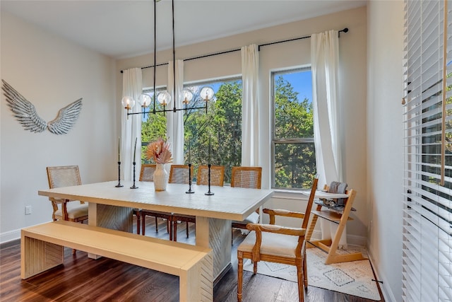 dining space featuring an inviting chandelier and dark wood-type flooring