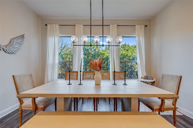 dining area featuring hardwood / wood-style flooring and a chandelier