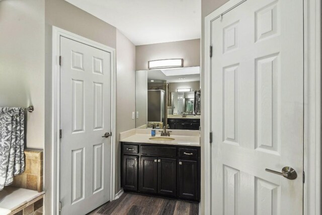 bathroom with vanity and hardwood / wood-style floors