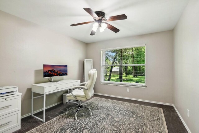 office featuring ceiling fan and dark carpet