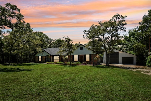 view of front of house with a garage and a yard