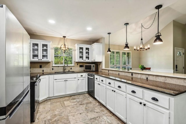 kitchen featuring appliances with stainless steel finishes, sink, kitchen peninsula, and pendant lighting