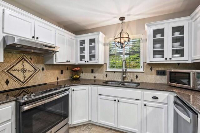 kitchen featuring white cabinetry, tasteful backsplash, stainless steel appliances, pendant lighting, and sink