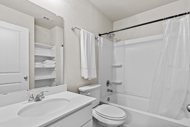 full bathroom featuring shower / tub combo with curtain, vanity, a textured ceiling, and toilet