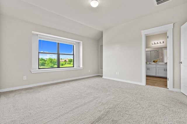 interior space with carpet and ensuite bath