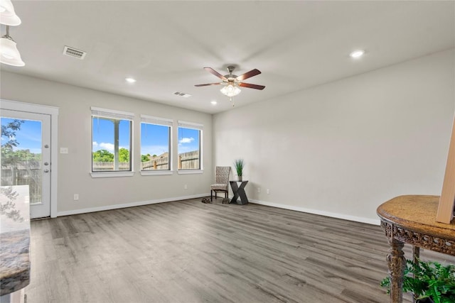 unfurnished room with dark hardwood / wood-style flooring and ceiling fan