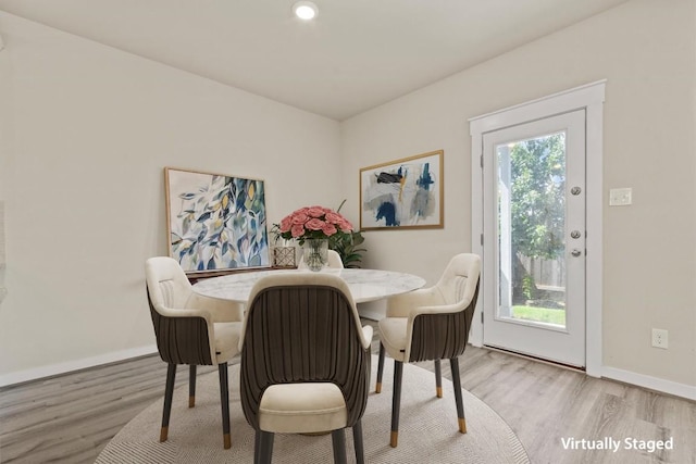 dining space with plenty of natural light and light hardwood / wood-style floors