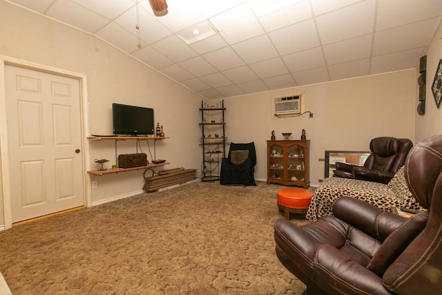 carpeted living room featuring vaulted ceiling, ceiling fan, a drop ceiling, and a wall unit AC