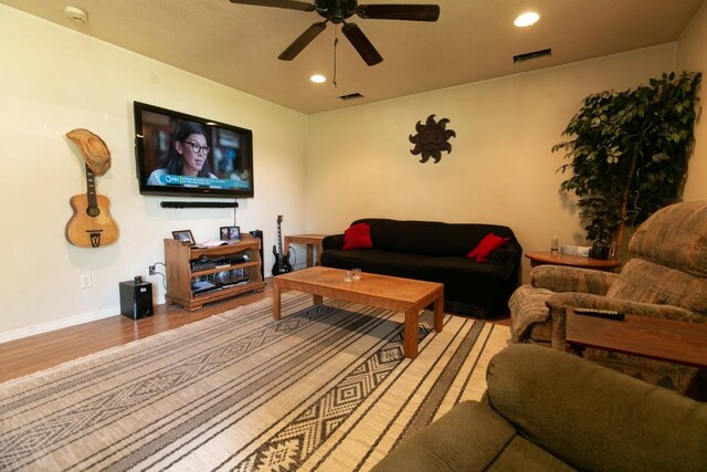 living room featuring ceiling fan and light hardwood / wood-style floors