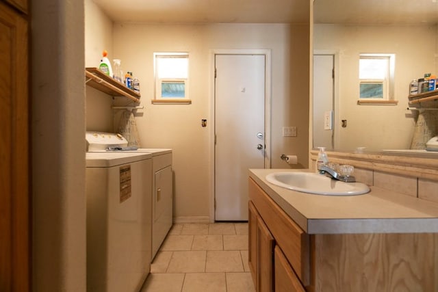 bathroom with tile patterned flooring, vanity, and washing machine and clothes dryer