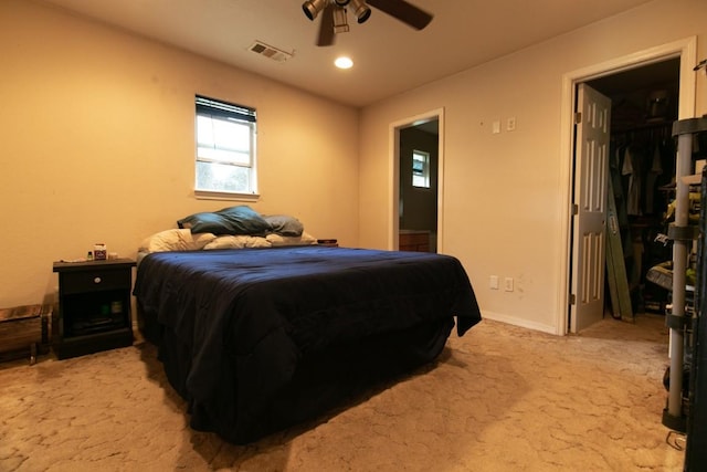 bedroom featuring a ceiling fan, visible vents, light carpet, and baseboards