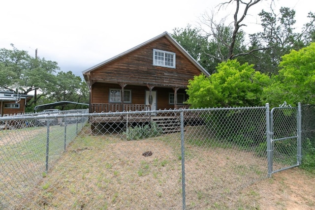 view of front of home featuring a porch and fence