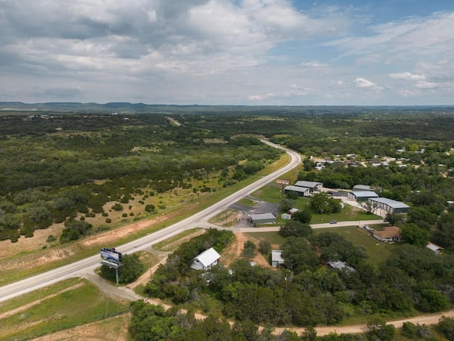 drone / aerial view featuring a forest view