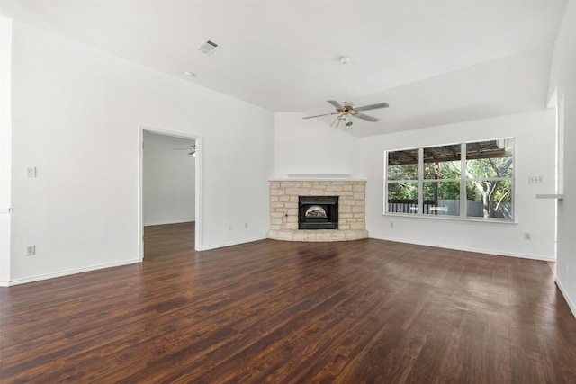 unfurnished living room with ceiling fan, a stone fireplace, and hardwood / wood-style flooring