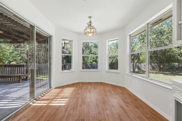 unfurnished sunroom with a notable chandelier