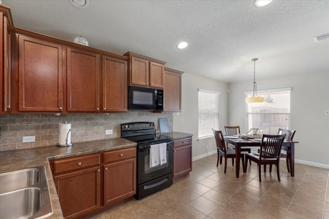 kitchen featuring light tile patterned floors, black appliances, a textured ceiling, and tasteful backsplash