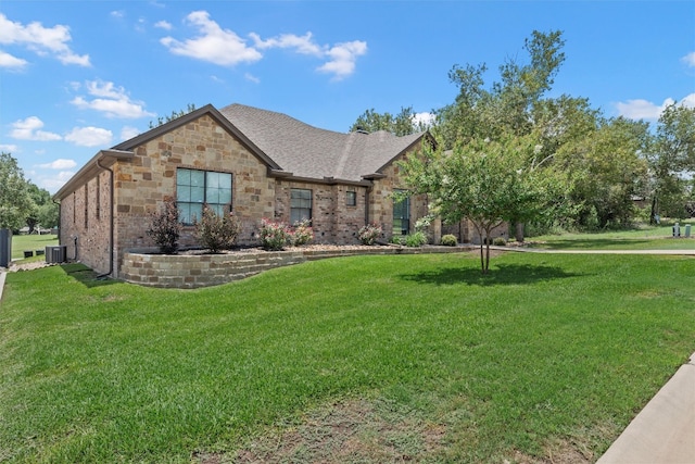 view of front of house with central air condition unit and a front yard