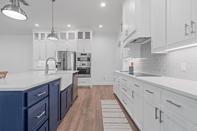 kitchen featuring white cabinetry, stainless steel appliances, blue cabinets, and light hardwood / wood-style flooring