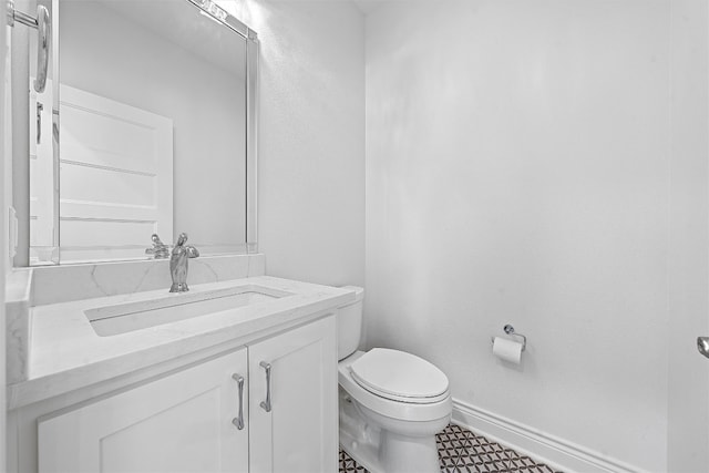 bathroom with vanity, toilet, and tile patterned floors