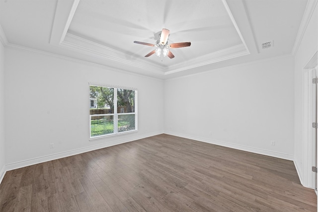 unfurnished room featuring wood-type flooring, ceiling fan, a raised ceiling, and crown molding