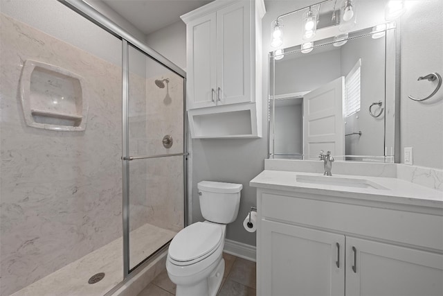 bathroom with vanity, walk in shower, tile patterned flooring, and toilet