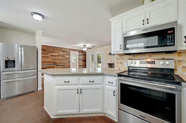 kitchen featuring kitchen peninsula, ceiling fan, backsplash, and stainless steel appliances