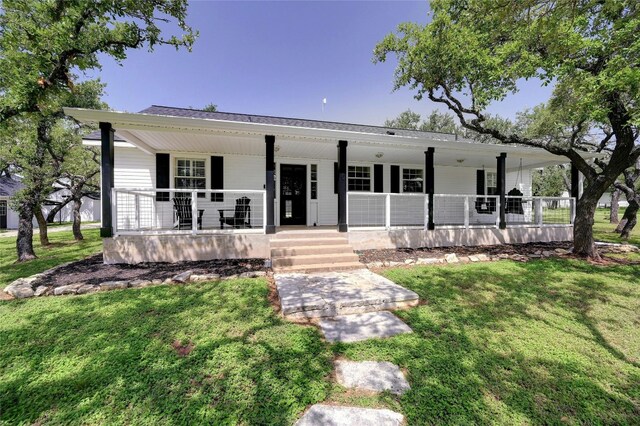 view of front of home with covered porch and a front lawn