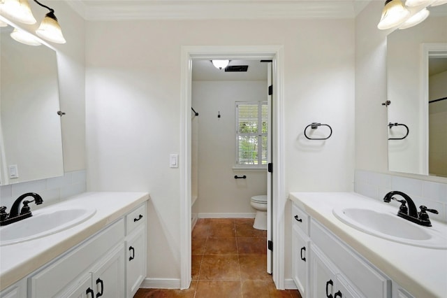 bathroom featuring tile patterned floors, vanity, decorative backsplash, and toilet