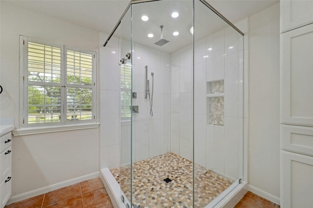 bathroom featuring walk in shower, tile patterned floors, and vanity