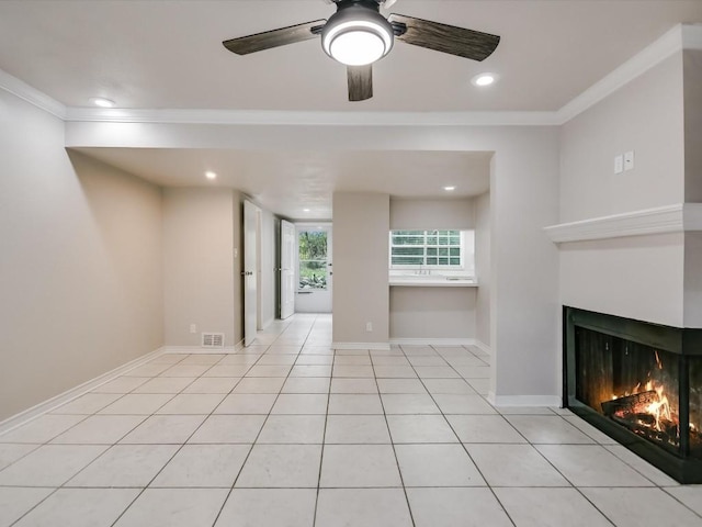 unfurnished living room with ceiling fan, light tile patterned flooring, and crown molding