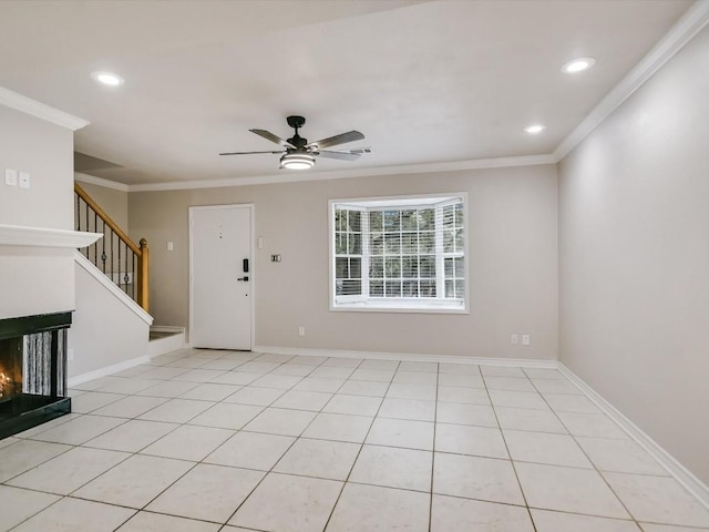 foyer featuring a multi sided fireplace, light tile patterned floors, ceiling fan, and crown molding