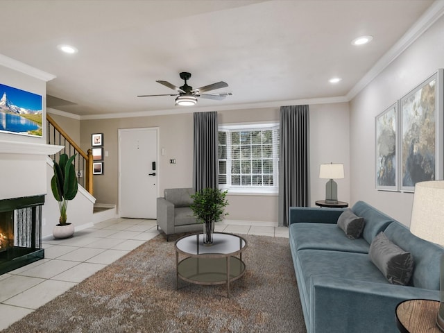 living room with ceiling fan, a multi sided fireplace, light tile patterned floors, and ornamental molding