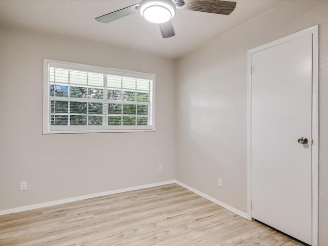 empty room featuring ceiling fan and light hardwood / wood-style flooring