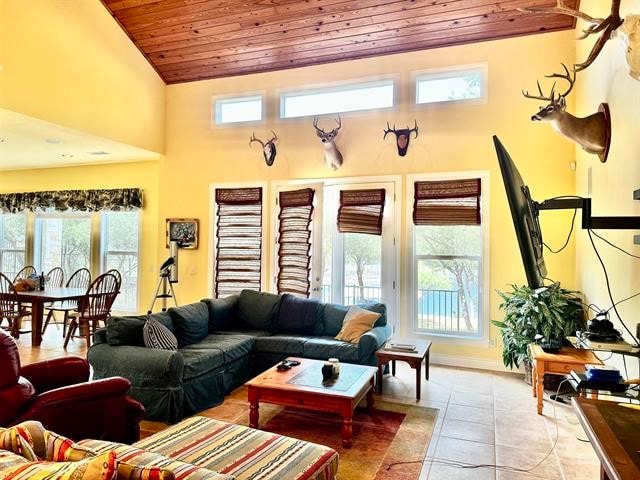 tiled living room with a healthy amount of sunlight, wood ceiling, and high vaulted ceiling