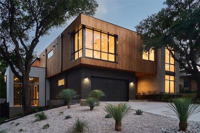 3003 Oakhaven Dr, Austin, TX 78704 - contemporary home featuring an attached garage, driveway, and brick siding