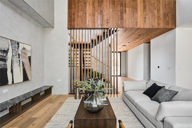 living room featuring a high ceiling and light wood-type flooring