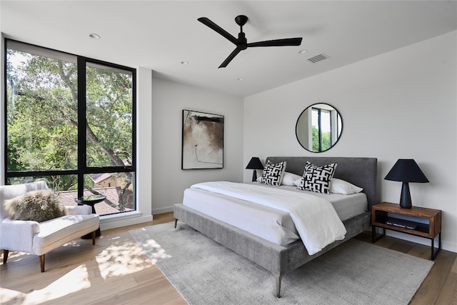 bedroom with wood-type flooring and ceiling fan